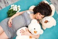 Beautiful pregnant mother with teddy bears. Motherhood Royalty Free Stock Photo