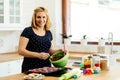 Beautiful pregnant woman baking muffins