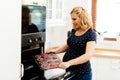 Beautiful pregnant woman baking muffins Royalty Free Stock Photo