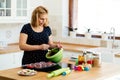 Beautiful pregnant woman baking muffins Royalty Free Stock Photo