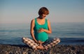 Beautiful pregnant woman on a beach