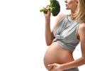 Beautiful pregnant woman big belly holding broccoli Pregnancy motherhood expectation healthy eating Royalty Free Stock Photo