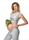 Beautiful pregnant woman big belly holding broccoli Pregnancy motherhood expectation healthy eating Royalty Free Stock Photo