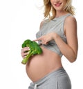 Beautiful pregnant woman big belly holding broccoli Pregnancy motherhood expectation healthy eating Royalty Free Stock Photo