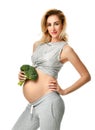 Beautiful pregnant woman big belly holding broccoli Pregnancy motherhood expectation healthy eating Royalty Free Stock Photo