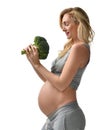 Beautiful pregnant woman big belly holding broccoli Pregnancy motherhood expectation healthy eating Royalty Free Stock Photo