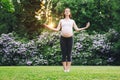 Beautiful pregnant woman doing prenatal yoga on nature outdoors. Royalty Free Stock Photo