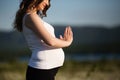 Beautiful pregnant woman doing sports in the camomile field Royalty Free Stock Photo