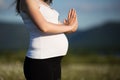 Beautiful pregnant woman doing yoga in the camomile field Royalty Free Stock Photo