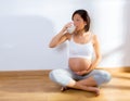 Beautiful pregnant woman drinking milk at home Royalty Free Stock Photo