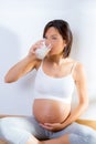 Beautiful pregnant woman drinking milk at home Royalty Free Stock Photo