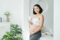 Beautiful pregnant woman drinking milk at home Royalty Free Stock Photo