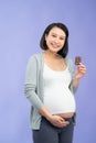 Beautiful pregnant woman eating chocolate at home Royalty Free Stock Photo