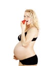 Beautiful pregnant woman eating red apple Royalty Free Stock Photo