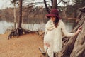 Beautiful pregnant woman in fashion hat on cozy warm outdoor walk