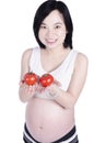 Beautiful pregnant woman with fresh tomato Royalty Free Stock Photo