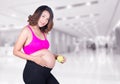 Beautiful pregnant woman with green apple in hospital Royalty Free Stock Photo