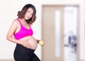 Beautiful pregnant woman with green apple in hospital Royalty Free Stock Photo