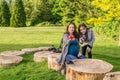 Beautiful pregnant woman and her daughter in a summer green park holding apple and cherry Royalty Free Stock Photo