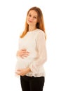 Beautiful pregnant woman holding belly isolated over white background Royalty Free Stock Photo