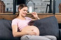 The pregnant woman holds a plate with cherry. Royalty Free Stock Photo