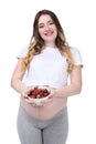 Pregnant woman holding bowl with strawberries Royalty Free Stock Photo