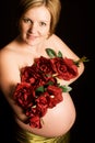 Beautiful pregnant woman holding flowers Royalty Free Stock Photo