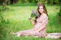 Beautiful pregnant woman holding flowers outdoors Royalty Free Stock Photo