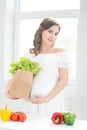 Beautiful pregnant woman in the kitchen Royalty Free Stock Photo