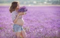 Beautiful pregnant woman in the lavender field.