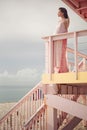 Beautiful pregnant woman on the lifeguard tower