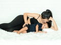 A beautiful pregnant woman lying in bed and caring for her son happily Royalty Free Stock Photo
