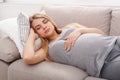 Beautiful pregnant woman napping on sofa Royalty Free Stock Photo