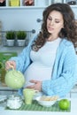 Pregnant woman pouring tea Royalty Free Stock Photo