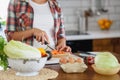 Beautiful pregnant woman preparing healthy meal with lots of vegetables at home Royalty Free Stock Photo