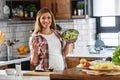 Beautiful pregnant woman preparing healthy meal with lots of vegetables at home Royalty Free Stock Photo