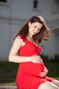 Beautiful pregnant woman in red dress