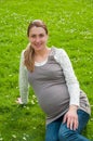 Beautiful pregnant woman relaxing in the park