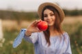 Beautiful pregnant woman show and eat red apple. Healthy food. Fresh fruits. Happy woman smile Royalty Free Stock Photo