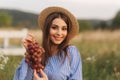 Beautiful pregnant woman show and eat red grapes. Healthy food. Fresh fruits. Happy woman smile Royalty Free Stock Photo