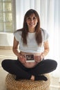Beautiful pregnant woman showing ultrasound scans