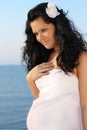 Beautiful pregnant woman on sky background