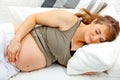 Beautiful pregnant woman sleeping on sofa at home Royalty Free Stock Photo