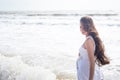 Beautiful pregnant woman smiling on the sea shore