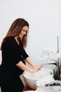 Beautiful pregnant woman smiling and washing hands at home using disinfectant and soap Royalty Free Stock Photo