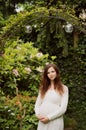 Beautiful pregnant woman standing in garden Royalty Free Stock Photo