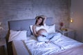 Pregnant woman watching TV in bed Royalty Free Stock Photo