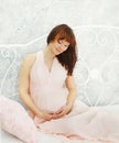 Beautiful pregnant young woman in gentle dress at home Royalty Free Stock Photo