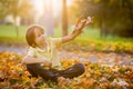 Beautiful preschool boy, playing with wooden plane in the park on sunset Royalty Free Stock Photo