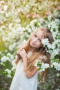 Beautiful preteen girl with long blond hair enjoy spring apple blooming. Royalty Free Stock Photo